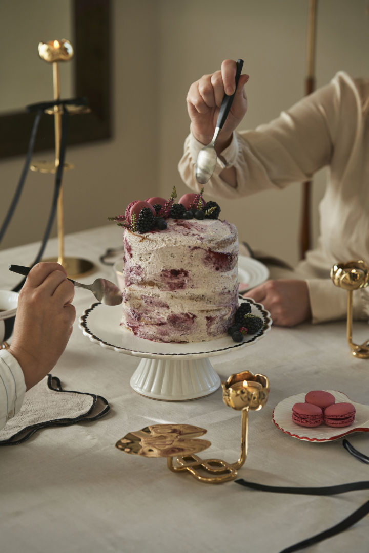 De nombreux produits Hilke sont présentés dans de jolis emballages cadeaux, comme ici sur une assiette Lines de NJRD, à côté de laquelle se trouve la tasse Strisce de Hilke, de couleur rose.