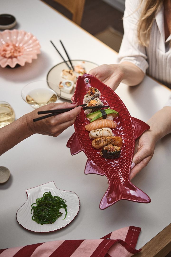 Le plat de service Kai de Byon a la forme d'un poisson en céramique émaillée bordeaux. Ici, le plat est utilisé pour servir des sushis et devient un détail frappant sur la table, c'est le moins que l'on puisse dire.