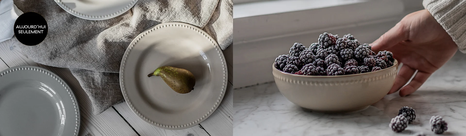Assiettes crème et grises à bord perlé avec une poire, et un bol de mûres givrées tenu par une main. Aujourd'hui seulement.